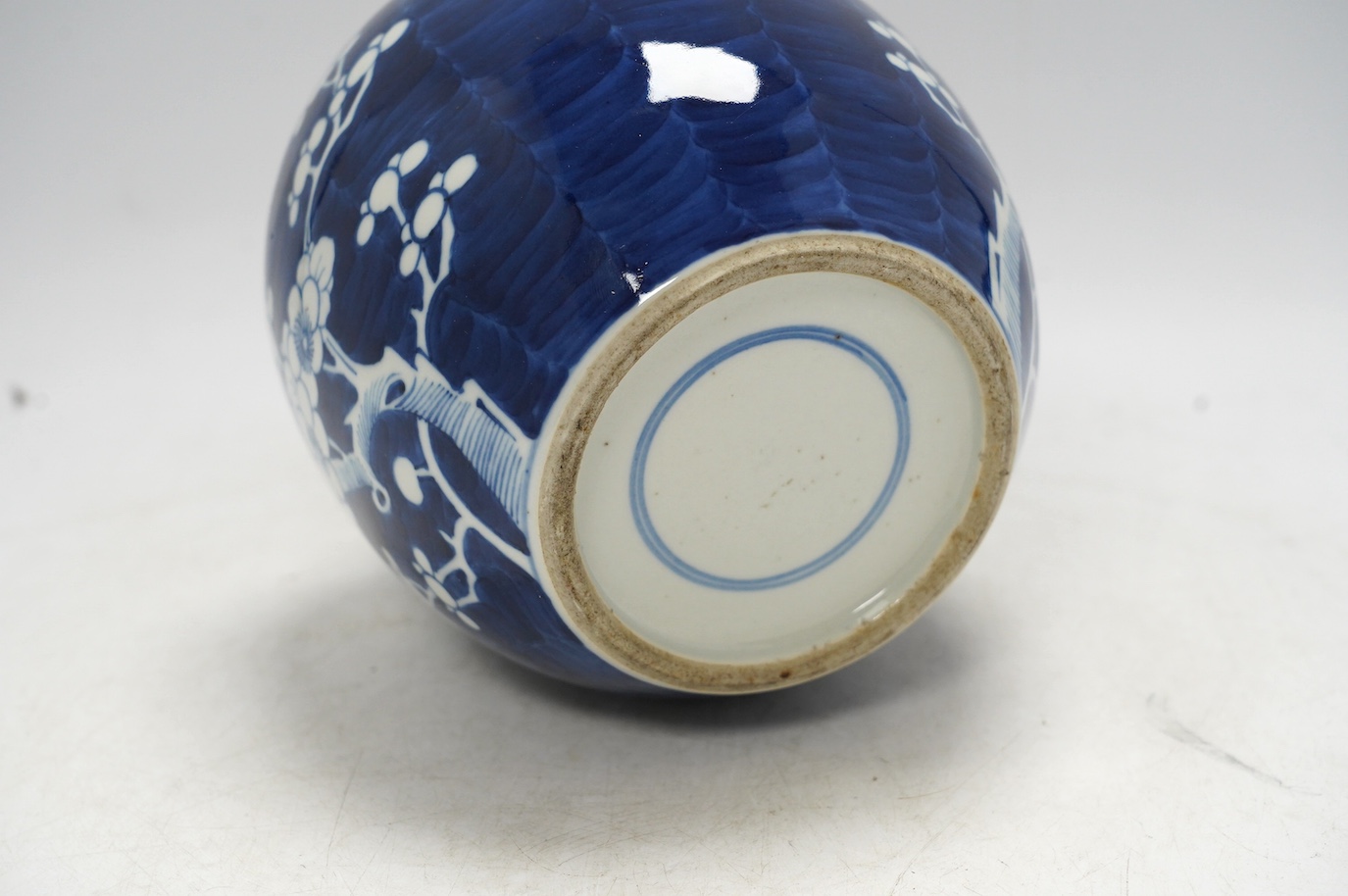 A Chinese blue and white prunus jar, with wood cover, early 20th century, 20.5cm high. Condition - good.